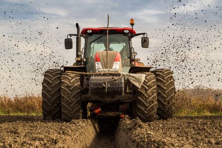 Tractor with double wheeled ditcher digging drainage canalの写真素材