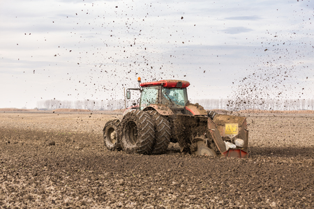 Tractor with double wheeled ditcher digging drainage canalの写真素材