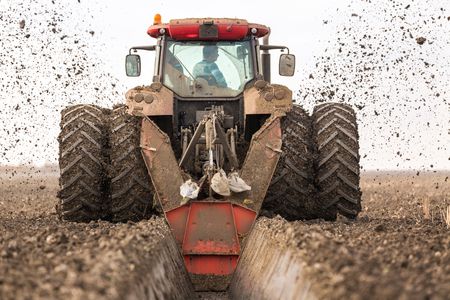 Tractor with double wheeled ditcher digging drainage canalの写真素材