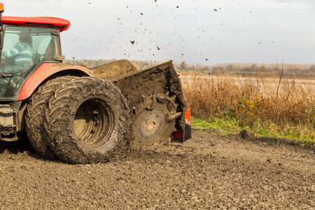 Tractor with double wheeled ditcher digging drainage canalの写真素材