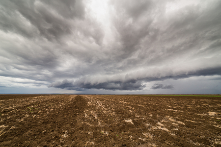 Storm clouds over arable landの写真素材