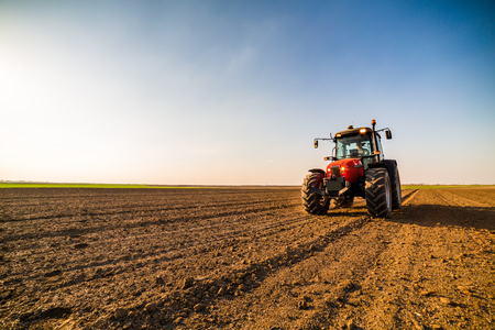 Farmer fertilizing arable land with nitrogen, phosphorus, potassium fertilizerの写真素材