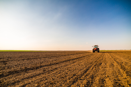 Farmer fertilizing arable land with nitrogen, phosphorus, potassium fertilizerの写真素材