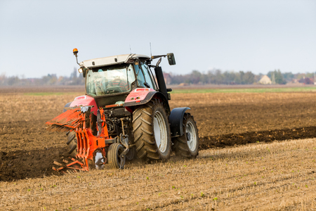 Farmer plowing stubble fieldの写真素材