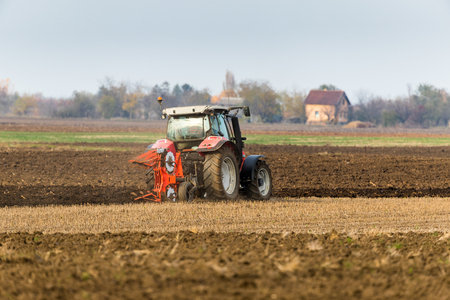 Farmer plowing stubble fieldの写真素材