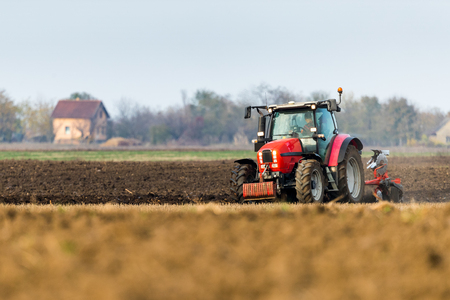 Farmer plowing stubble fieldの写真素材
