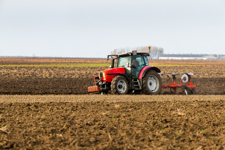 Farmer plowing stubble fieldの写真素材