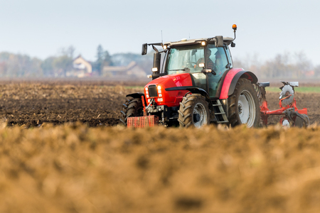 Farmer plowing stubble fieldの写真素材
