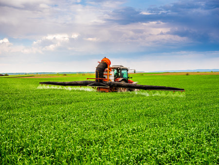 Farmer spraying wheat cropsの写真素材