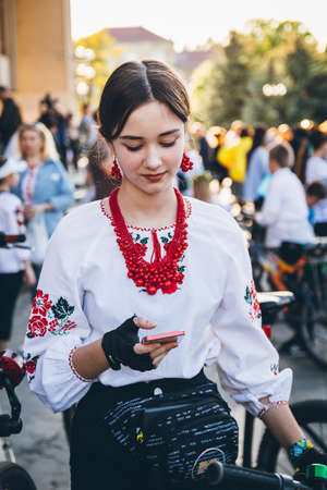 Woman in Ukrainian national embroidered shirts take part in a bicycle race in support of Ukraine against the Russian invasion. Event bike city ride in Uzhhorod, Ukraine - May 2022のeditorial素材