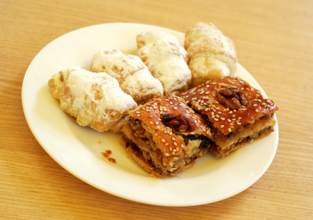Cake and sweets on a plate on a wooden background