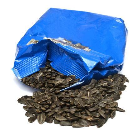 Seeds spill out of the package isolated on white backgroundの写真素材