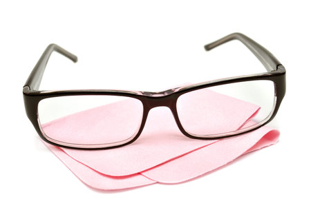 Glasses with cloth for care isolated on white background