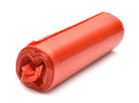 Garbage bag in red isolated on white backgroundの写真素材