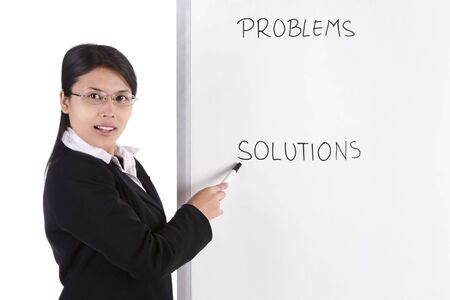 A business woman pointing at the white board in her presentation. There is words in the white board, you can replaced it with any words you want.の写真素材