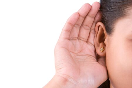 A woman trying to hearing the sound around her, taken close up to the ear and be focused around there.の写真素材