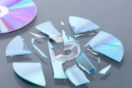 A broken disk into peces and the damaged one that not in focus.の写真素材