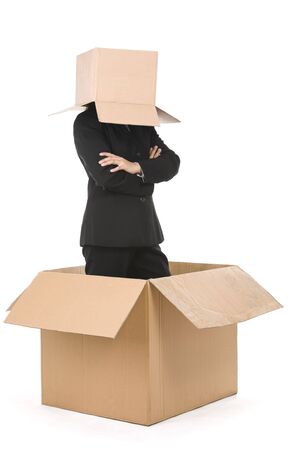 A businesswoman stand inside a box with her head is covered with smaller box. Smiling face can be drawn on the box (I draw angry face for my personal project).の写真素材