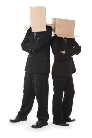 Businessman and businesswoman are standing side by side in stylish position with their head covered by boxes. You can draw smiley or angry face on the box surface.の写真素材
