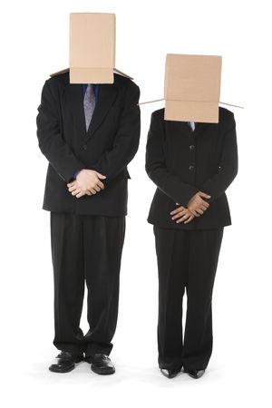 Businessman and businesswoman are standing in welcoming position with their head covered with box. You can draw smiley face on the box surface.の写真素材