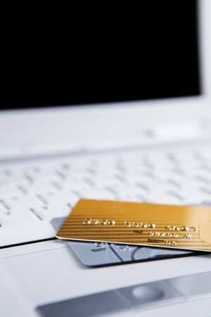 Two credit cards on the laptop, all the important information has been removed from them.の写真素材