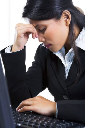 Side view of a depressed young businesswoman in her office.の写真素材