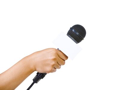 Side view of a bare hand holding a microphone aiming to the empty space on right with 90 degrees from the camera.の写真素材