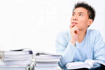 A young scholar is looking away - thinking for an idea.の写真素材