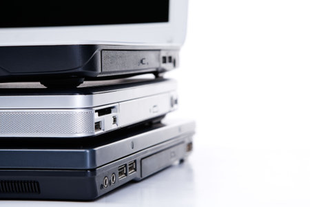 Pile of three laptops, with the top openの写真素材