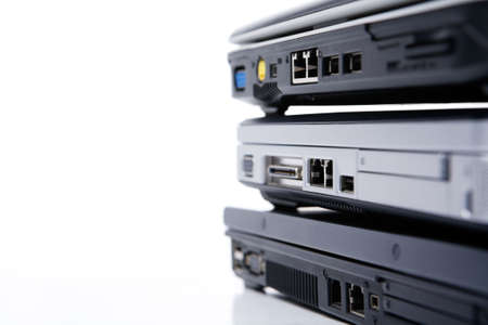 Pile of three laptops, with the top openの写真素材