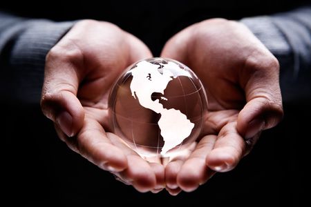 Hands holding a glass globe showing America continentの写真素材