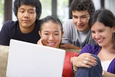 A group of multi ethnic student watching the laptopの写真素材
