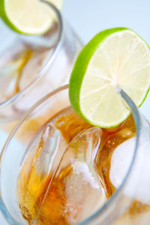 Zoom version of soft drinks (ice tea or cola), shot from above on blue surface