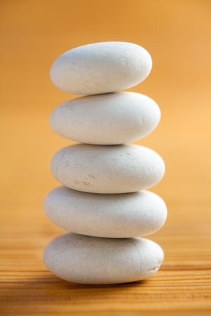 Pile of white stone arranged in stable position on spa location with natural lighting. PS : very shallow depth of field, main focus on the third line stone near the front areaの写真素材