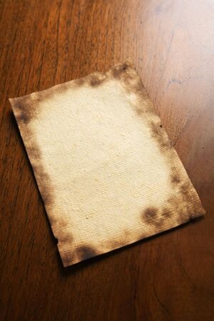 Old blank paper and a scroll on wooden tableの写真素材