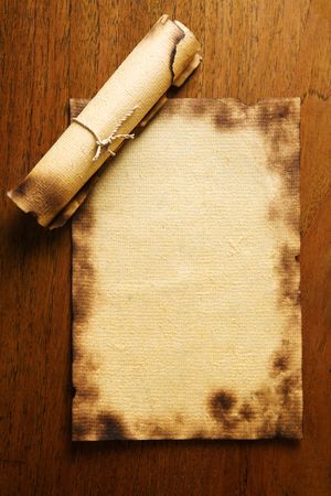 Old blank paper and a scroll on wooden tableの写真素材