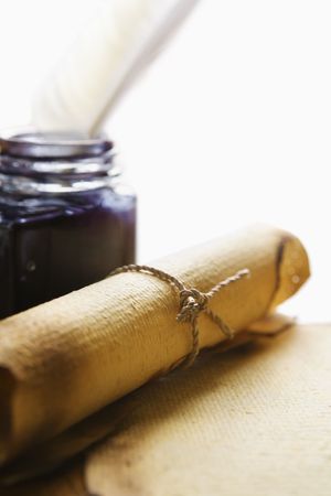 Old blank paper, scroll with quill pen and ink on wooden tableの写真素材