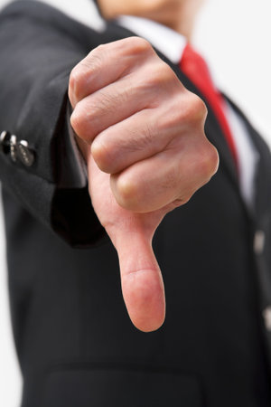 A businessman showing thumb down to reject