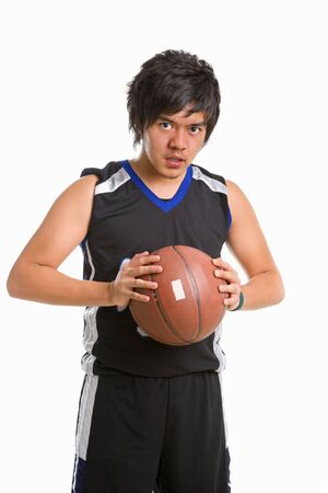 Basketball player holding ball while gazing to cameraの写真素材