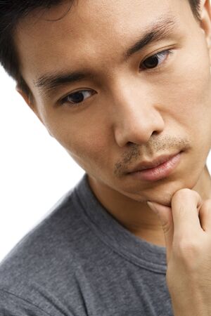 Portrait of sad expression of Asian young manの写真素材