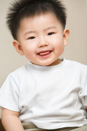 Expression of playful Asian toddler at home