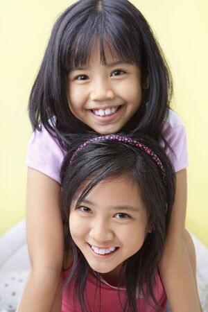 Two young girls in bedroomの写真素材