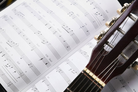 close up of a classic guitar and musical chords bookの写真素材
