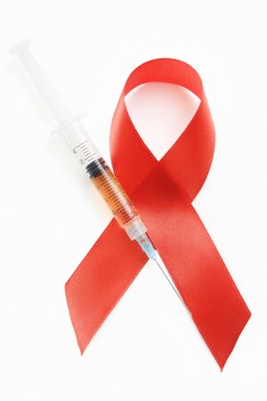 Red ribbon symbol and syringe use for a campaign against drugs and AIDSの写真素材