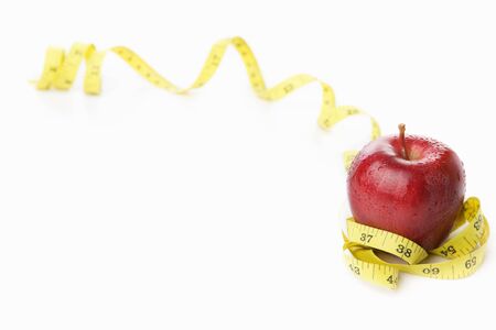 Red apple with measuring tape for diet and healthy life concept with lots of copy spaceの写真素材