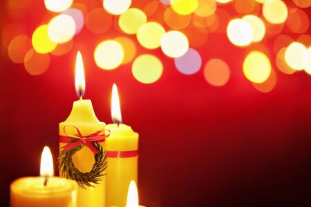 Christmas candle with blurred light on dark backgroundの写真素材