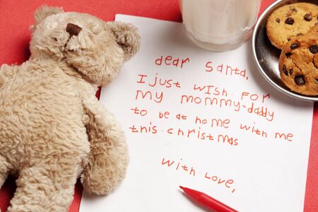 Honest child Christmas wish with teddy bear doll, cookies and milk. Concept for lonely child and orphan for Christmasの写真素材