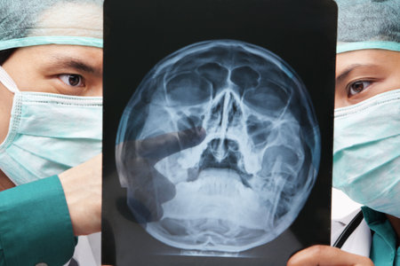 Two Asian surgeon discuss over skeleton roentgen between them