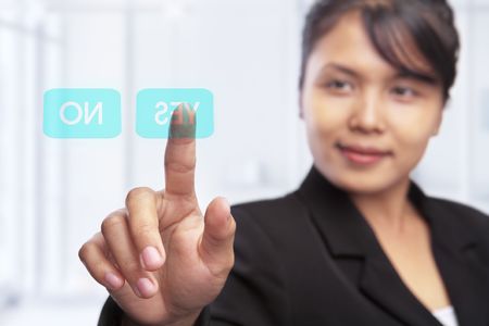 Asian businesswoman and option between yes and no on touch screenの写真素材