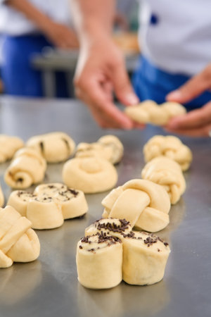 Making sweet bread, main focus on the front bread dought, very shallow depth of field